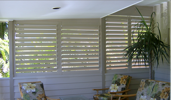 Outdoor Aluminium Shutters installed in alfresco area, colour white with louver slats partially open allowing light to enter the area and yet still block out the harsh direct sunlight.