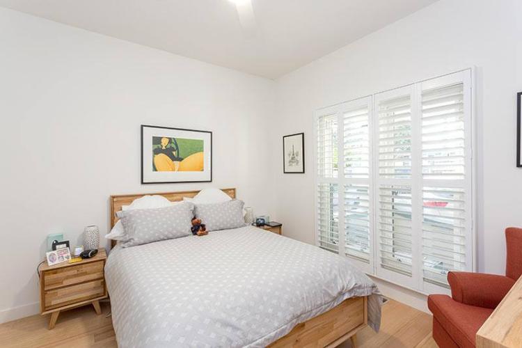 white-plantation-shutters-bedroom-open